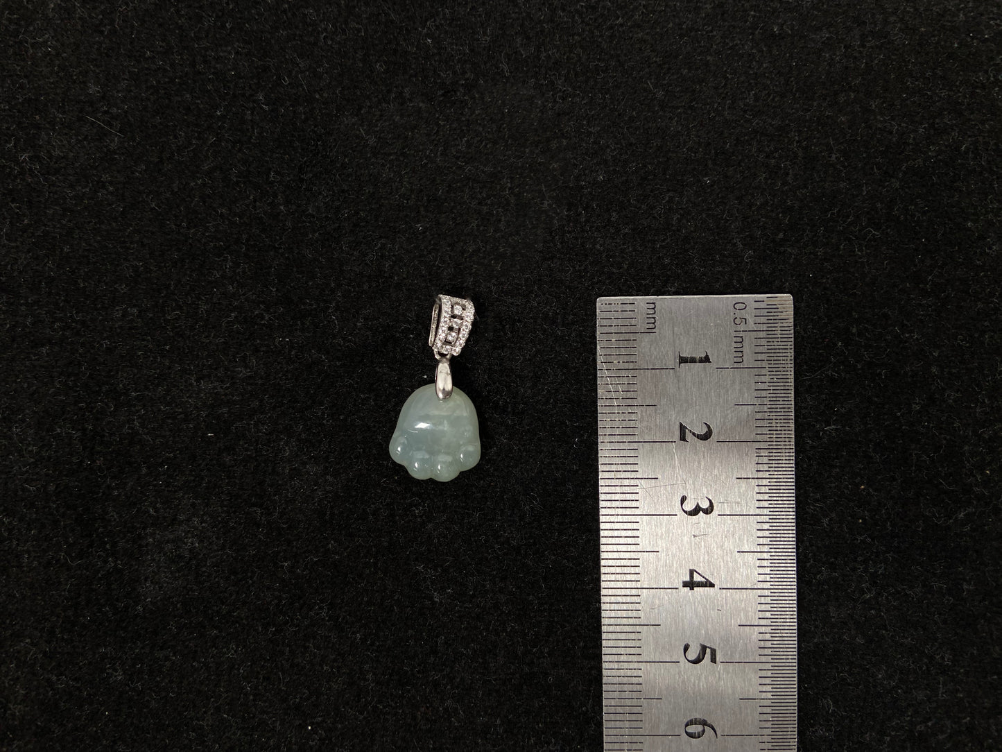 A light green jadeite cat paw pendant.