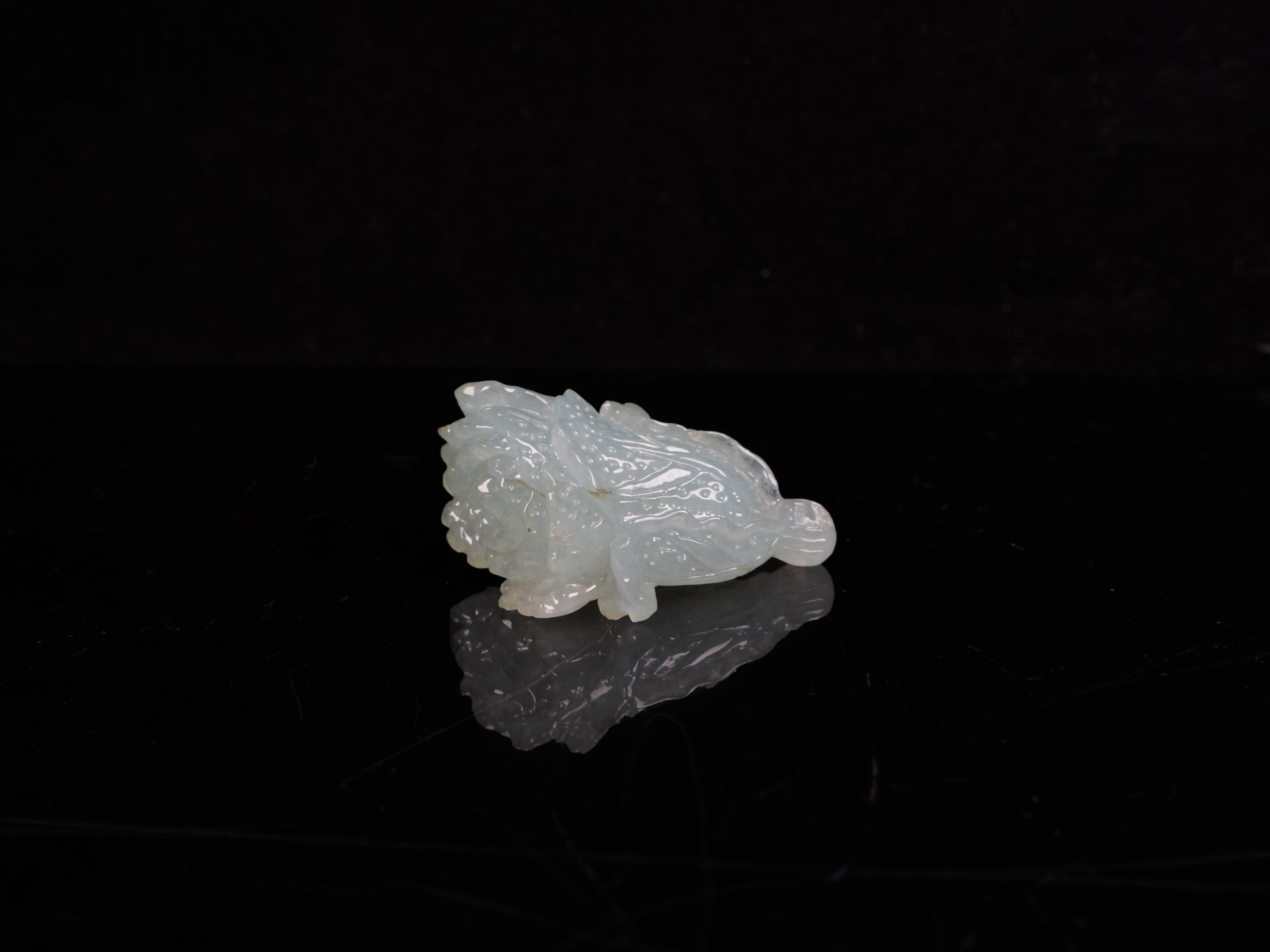 A delicate icy light green cabbage loose jadeite.