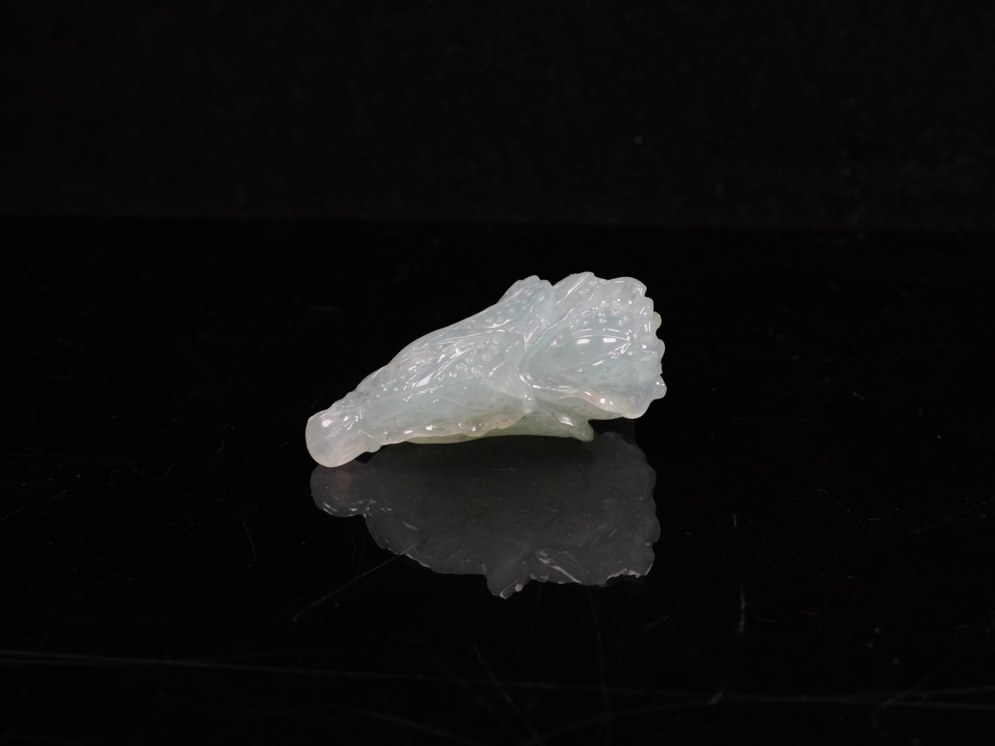 A delicate icy light green cabbage loose jadeite.