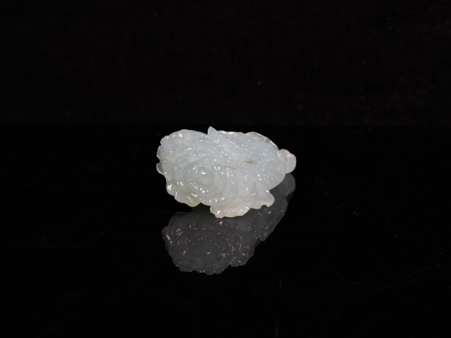 A delicate icy light green cabbage loose jadeite.