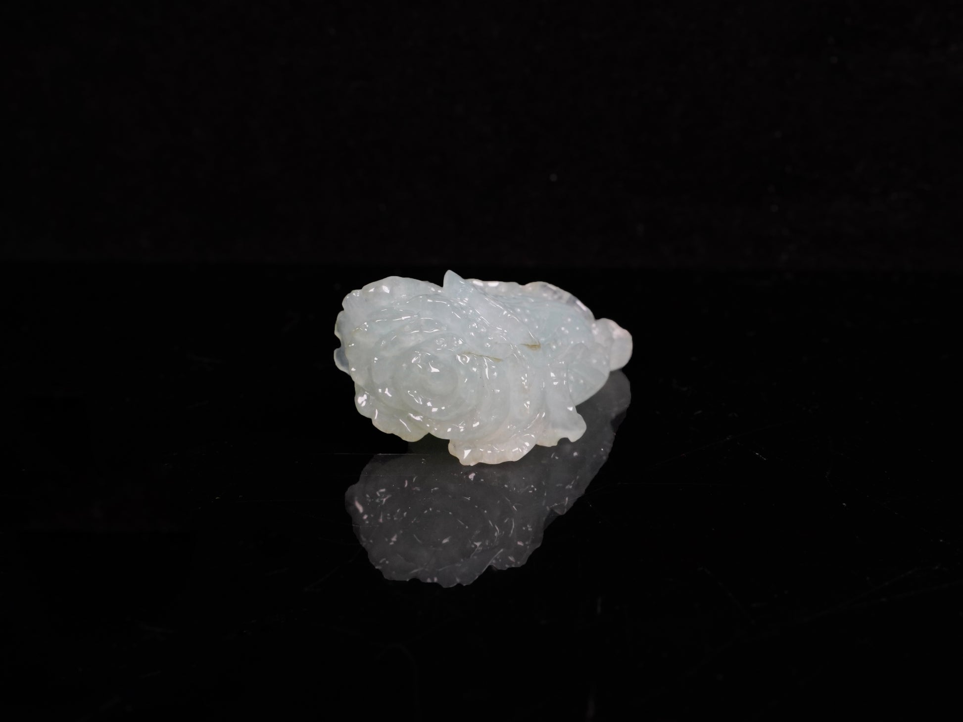 A delicate icy light green cabbage loose jadeite.