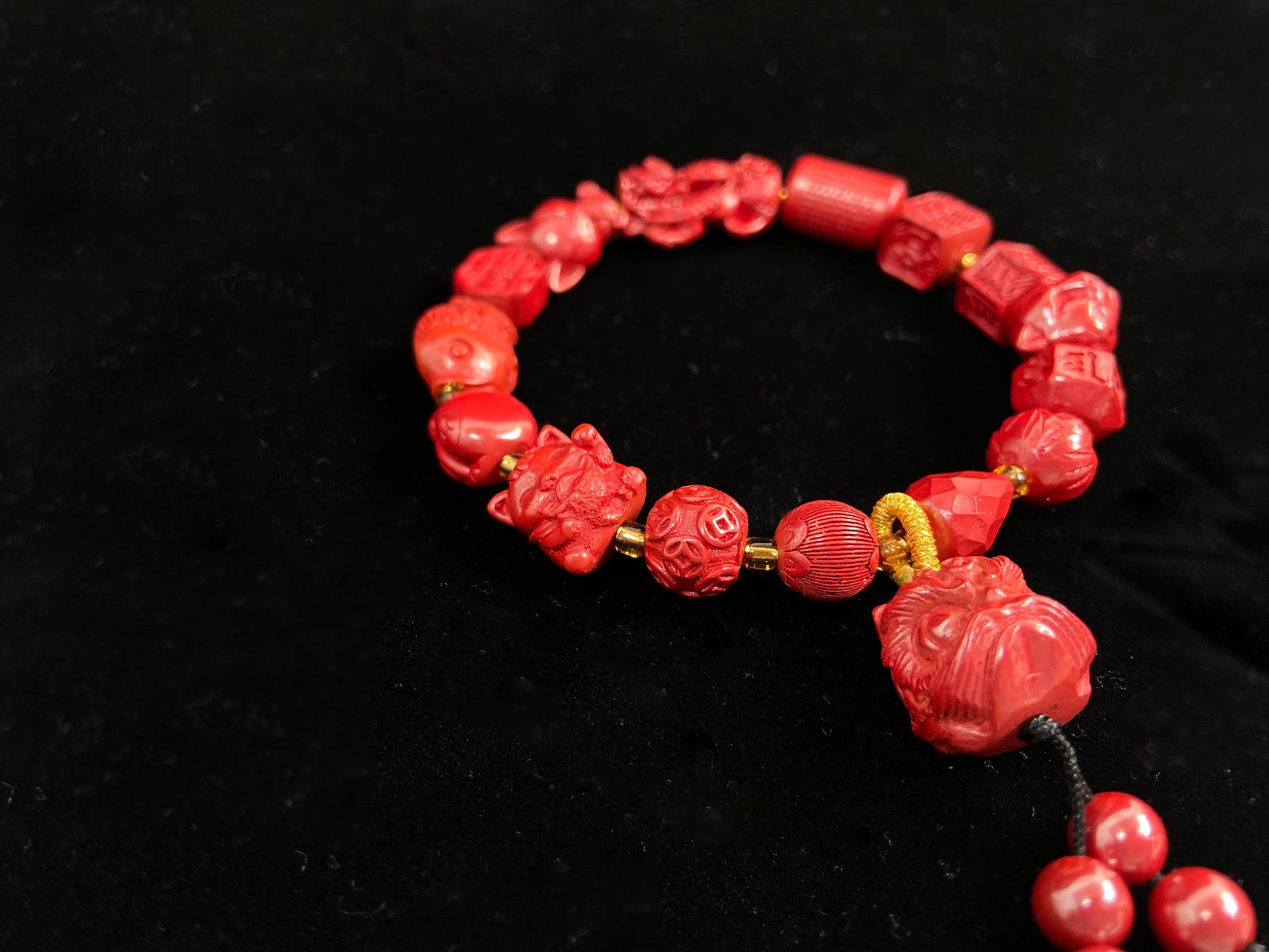 This cinnabar bracelet features various beads, such as coins, guardian lions, nine-tailed foxes, and more.