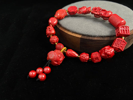 This cinnabar bracelet features various beads, such as coins, guardian lions, nine-tailed foxes, and more.