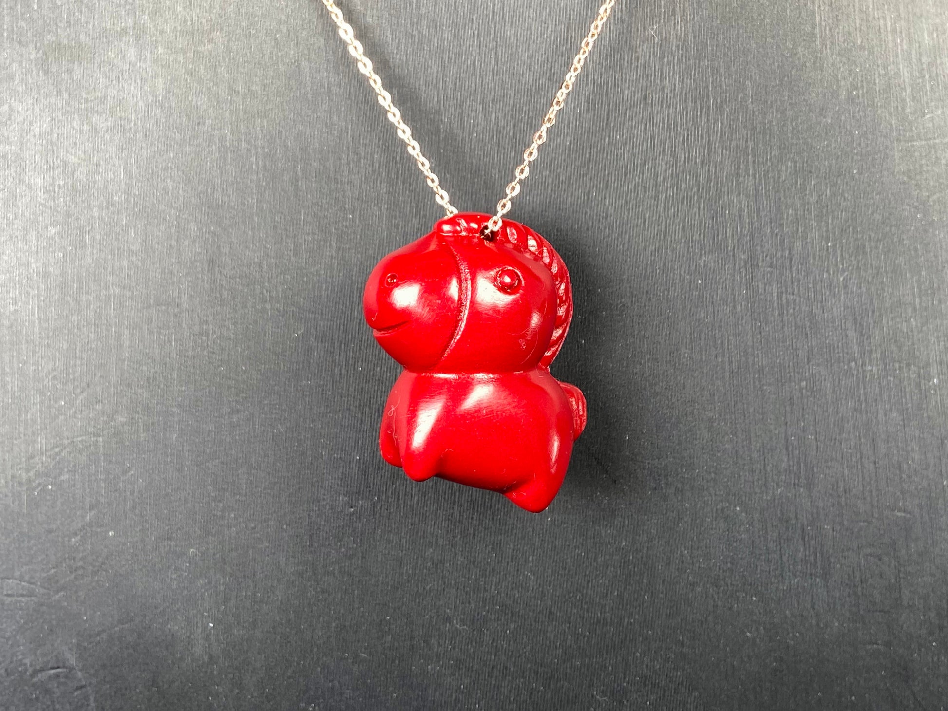 A red cute fortune horse cinnabar pendant.
