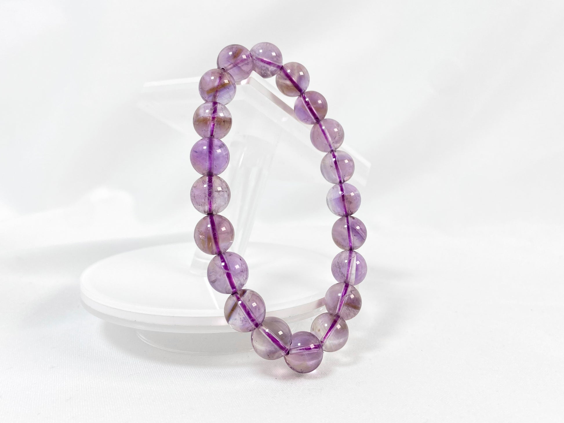 A bead strand crafted from ametrine crystals.