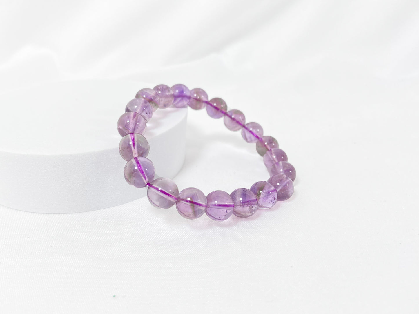 A bead strand crafted from ametrine crystals.