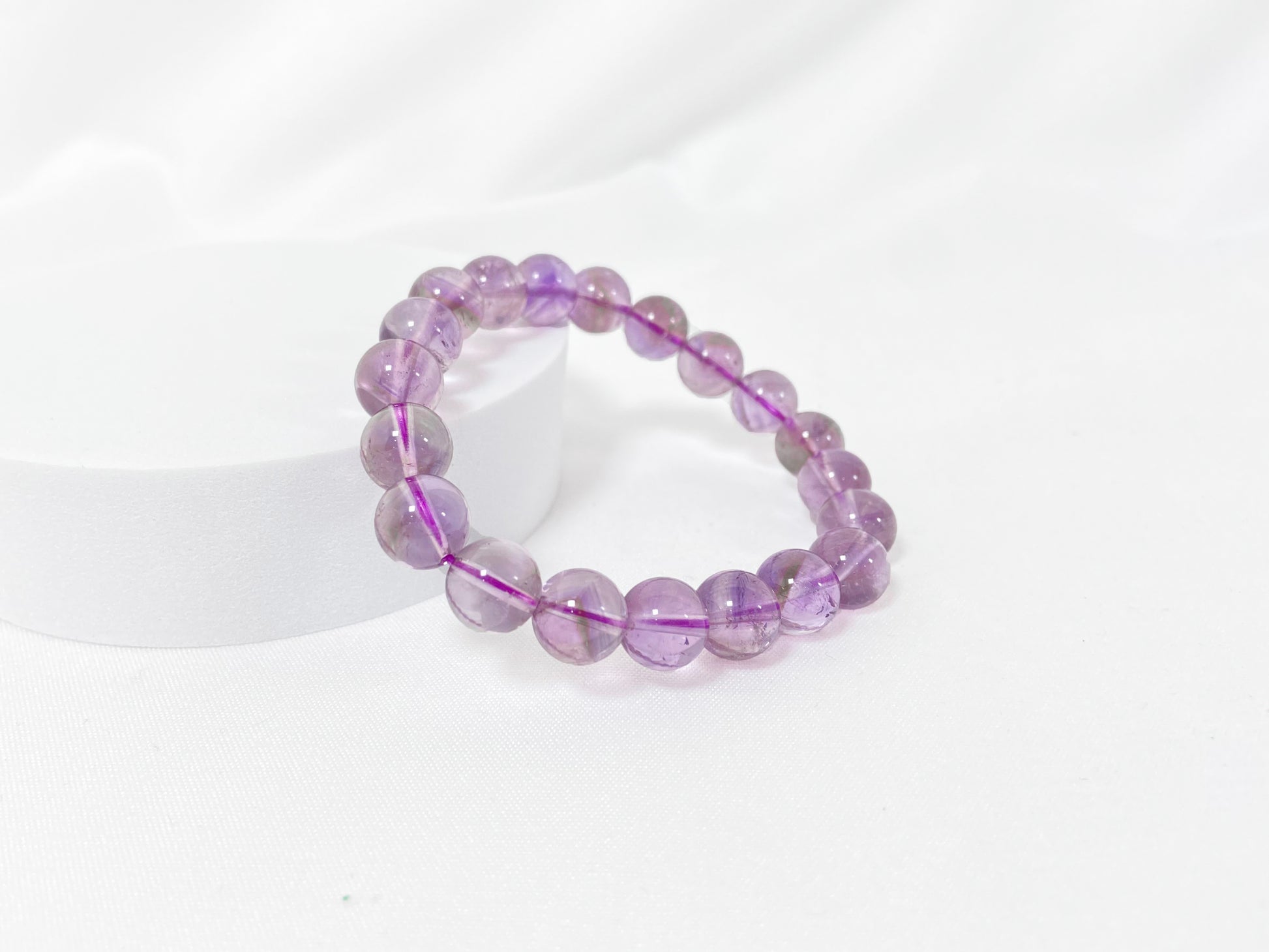 A bead strand crafted from ametrine crystals.