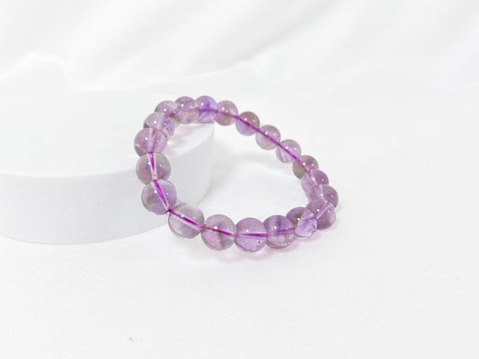 A bead strand crafted from ametrine crystals.