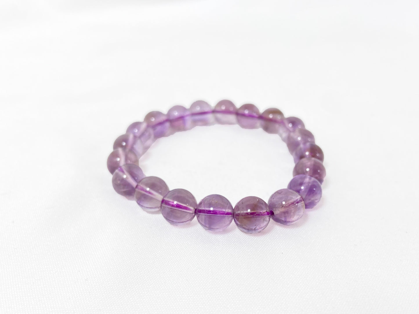 A bead strand crafted from ametrine crystals.