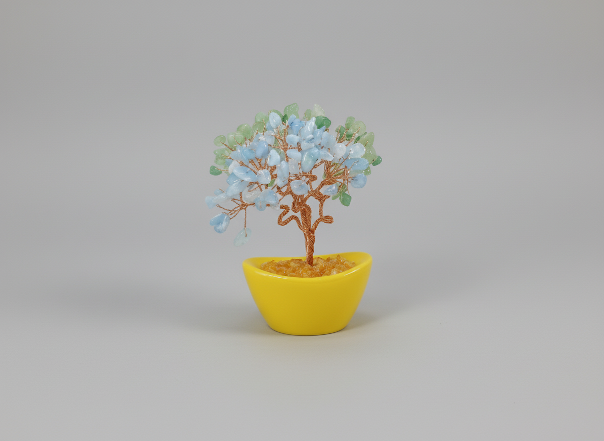 Decorative tree with blue and green leaves in a yellow pot on a white background