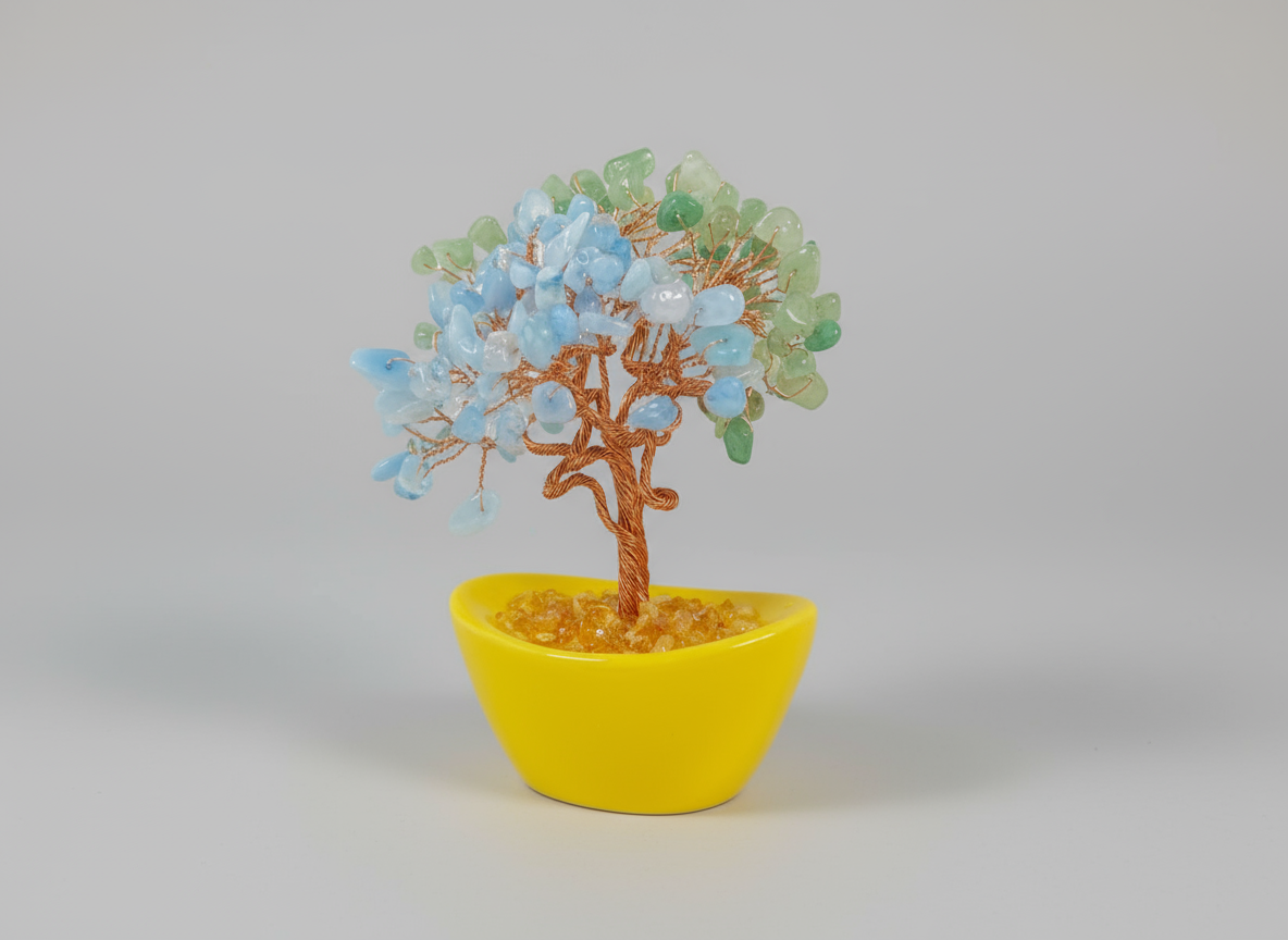 Decorative tree with blue and green leaves in a yellow pot on a white background