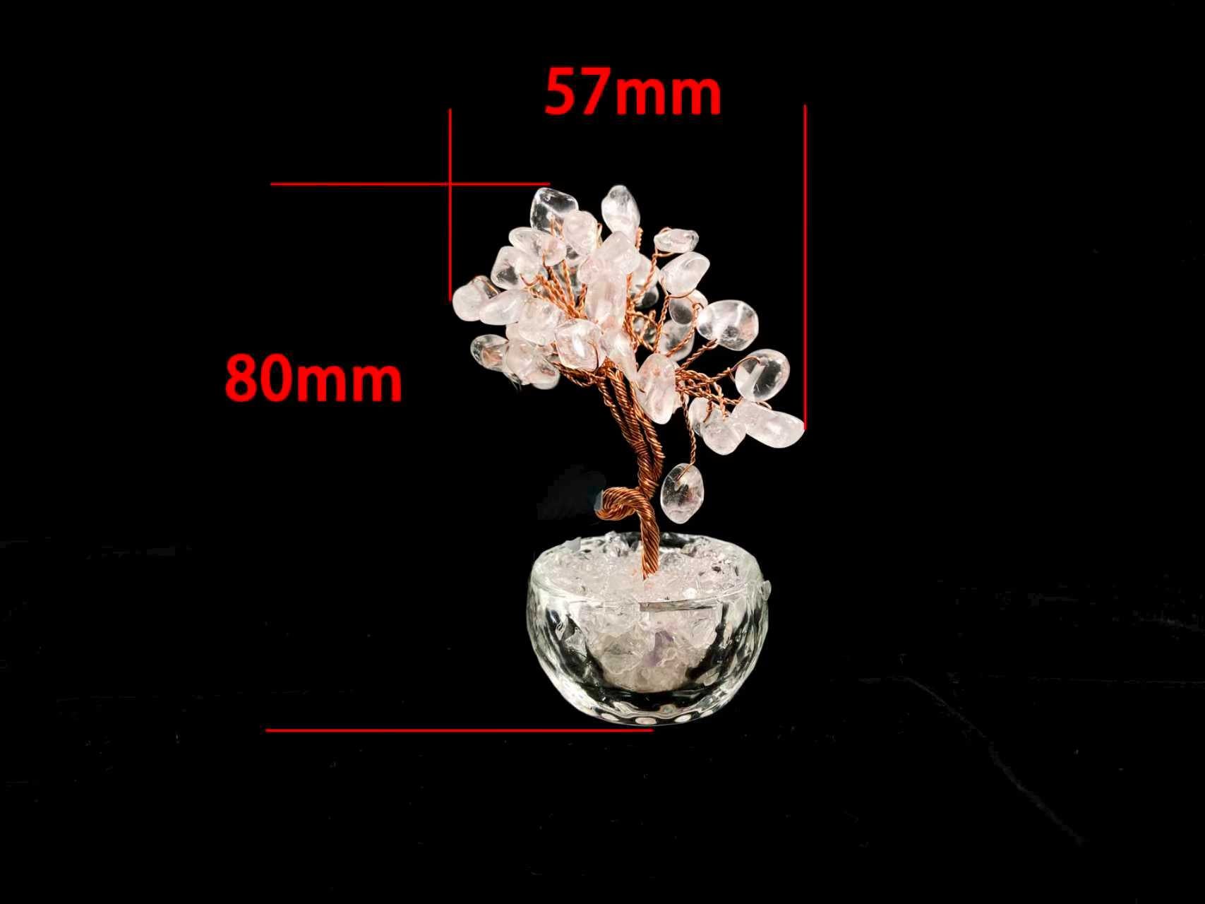 A rose quartz crystal tree in a clear glass pot.