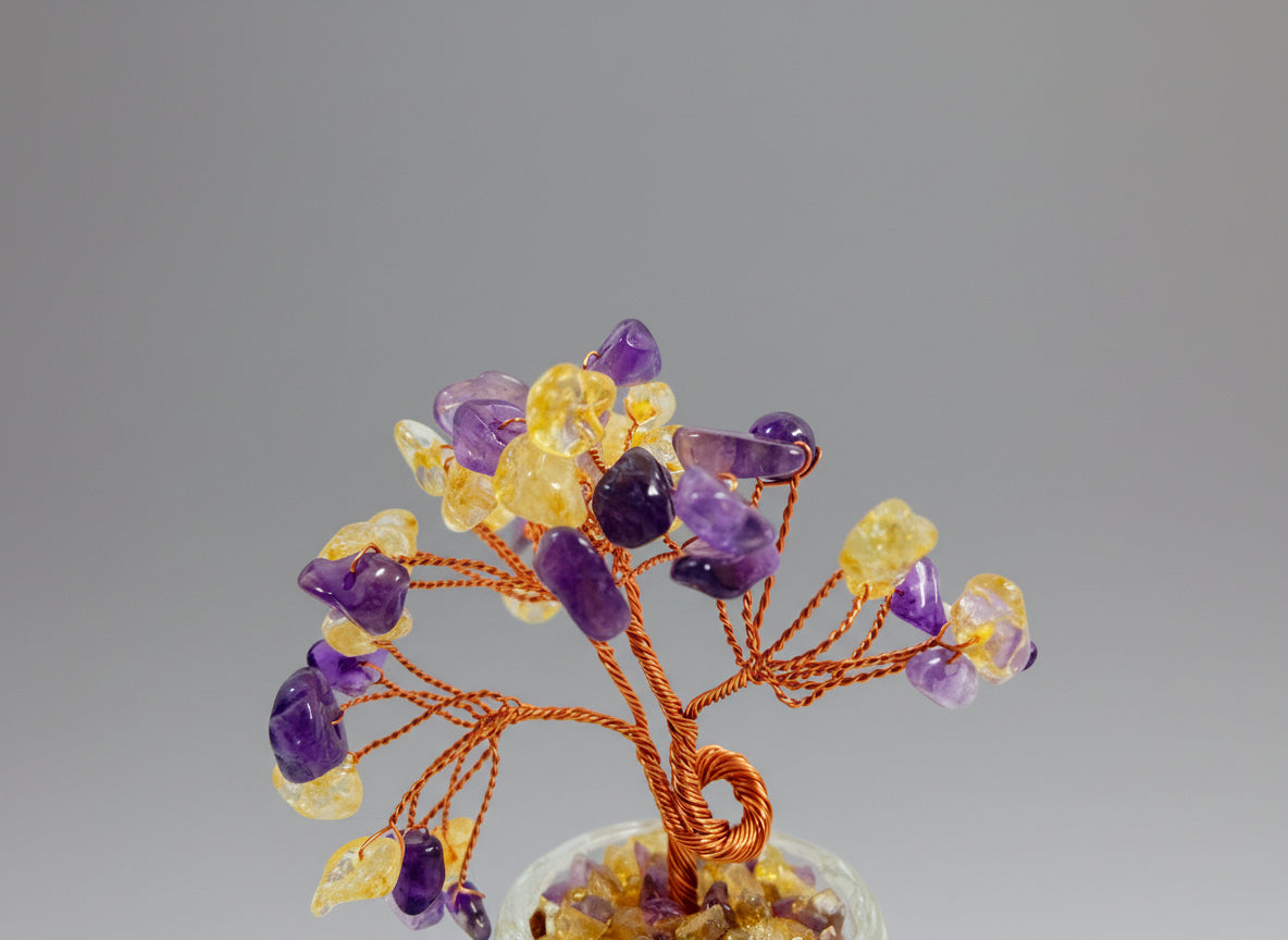 This crystal tree is crafted from Amethyst-Citrine, a unique natural bicolor crystal.
