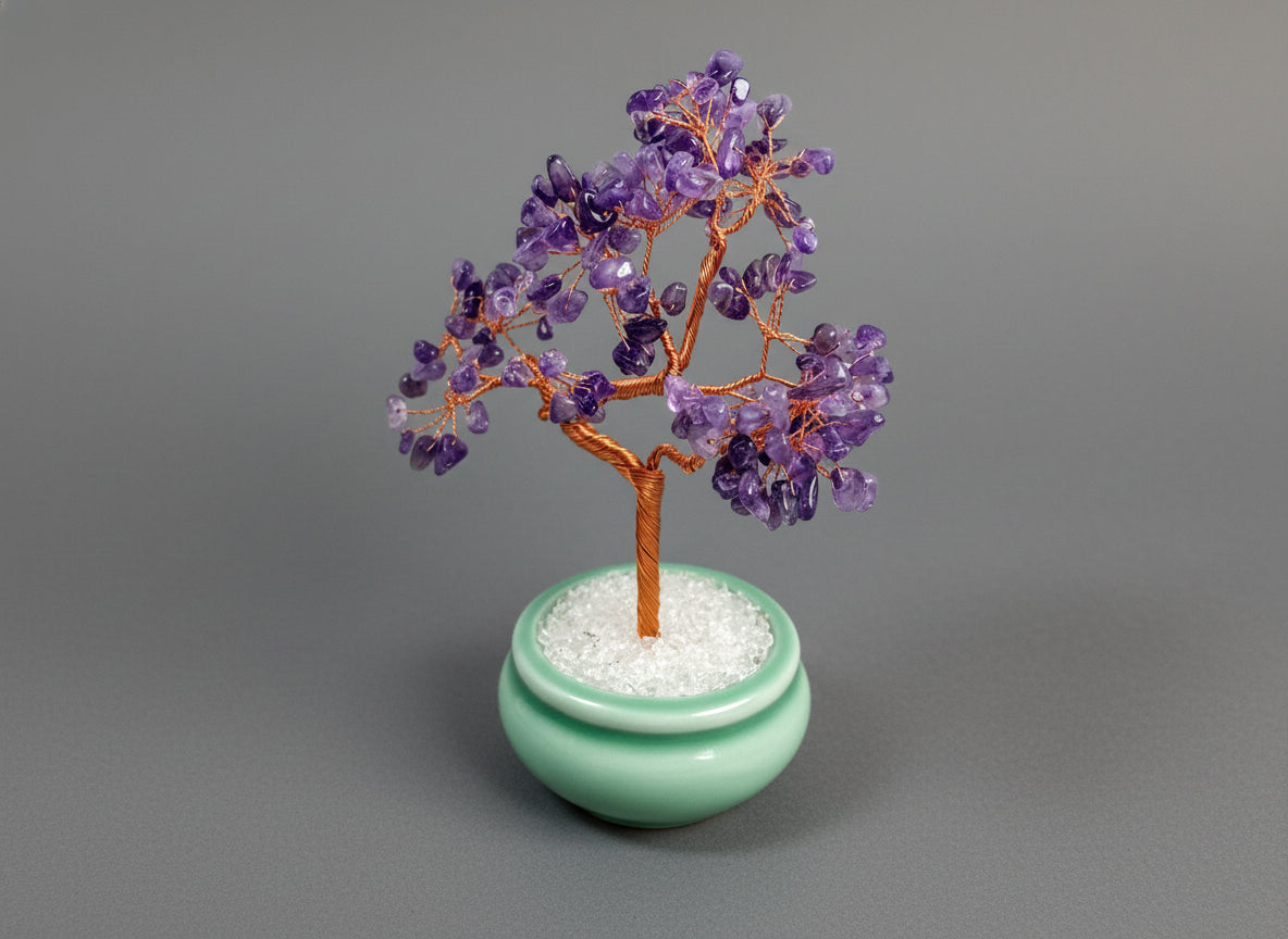 A amethyst crystal tree in a green pot.