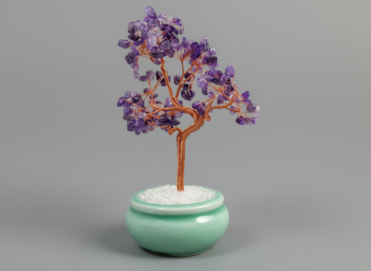 A amethyst crystal tree in a green pot.
