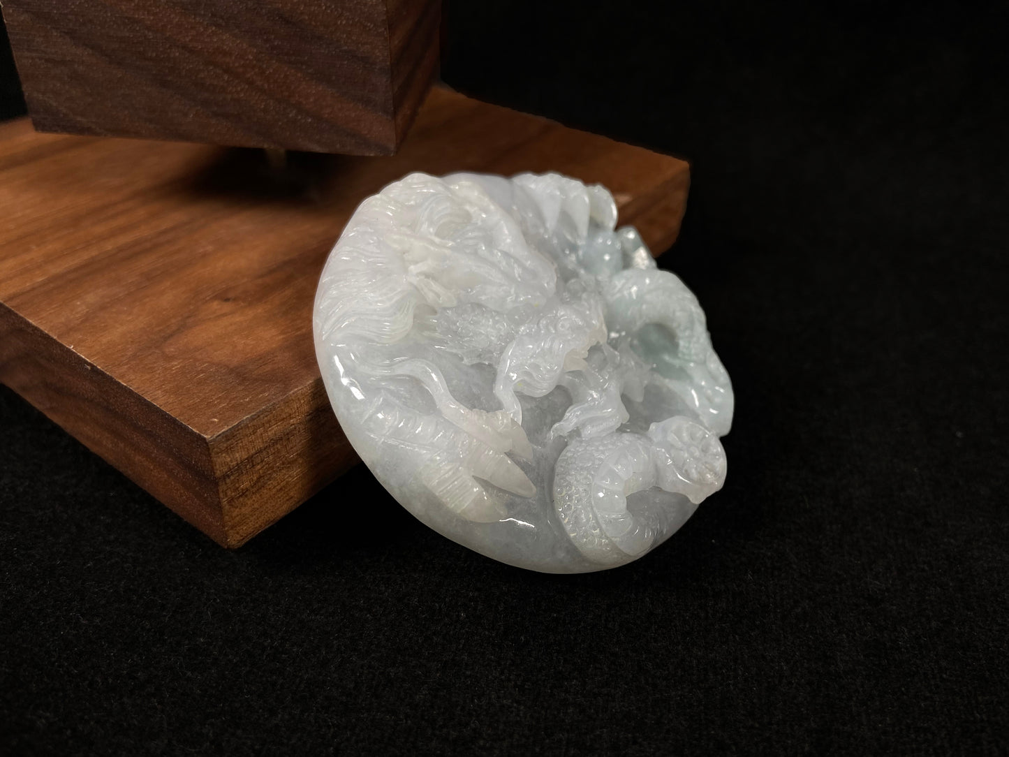 A creamy white jadeite disc carved with a dragon.