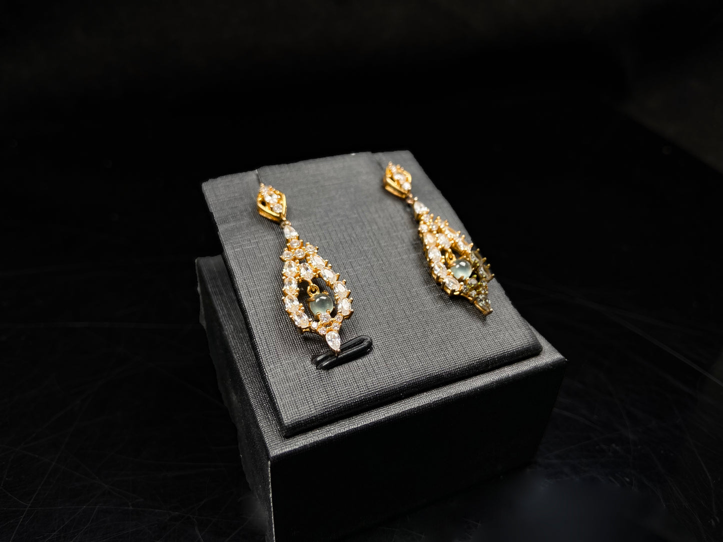 A  pair of diamond halo clear teardrop jadeite earrings.