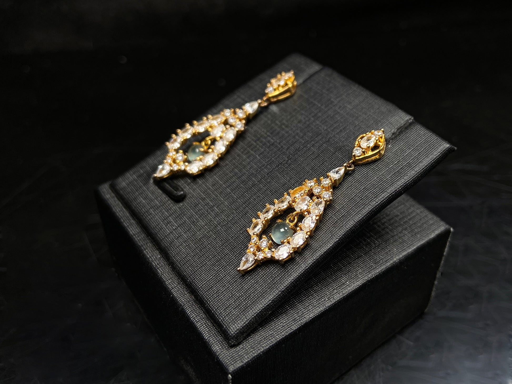 A  pair of diamond halo clear teardrop jadeite earrings.