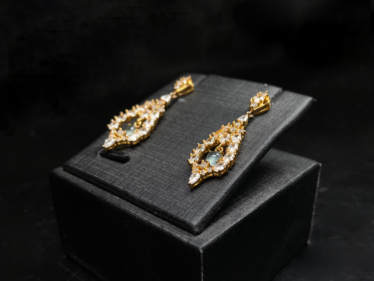 A  pair of diamond halo clear teardrop jadeite earrings.