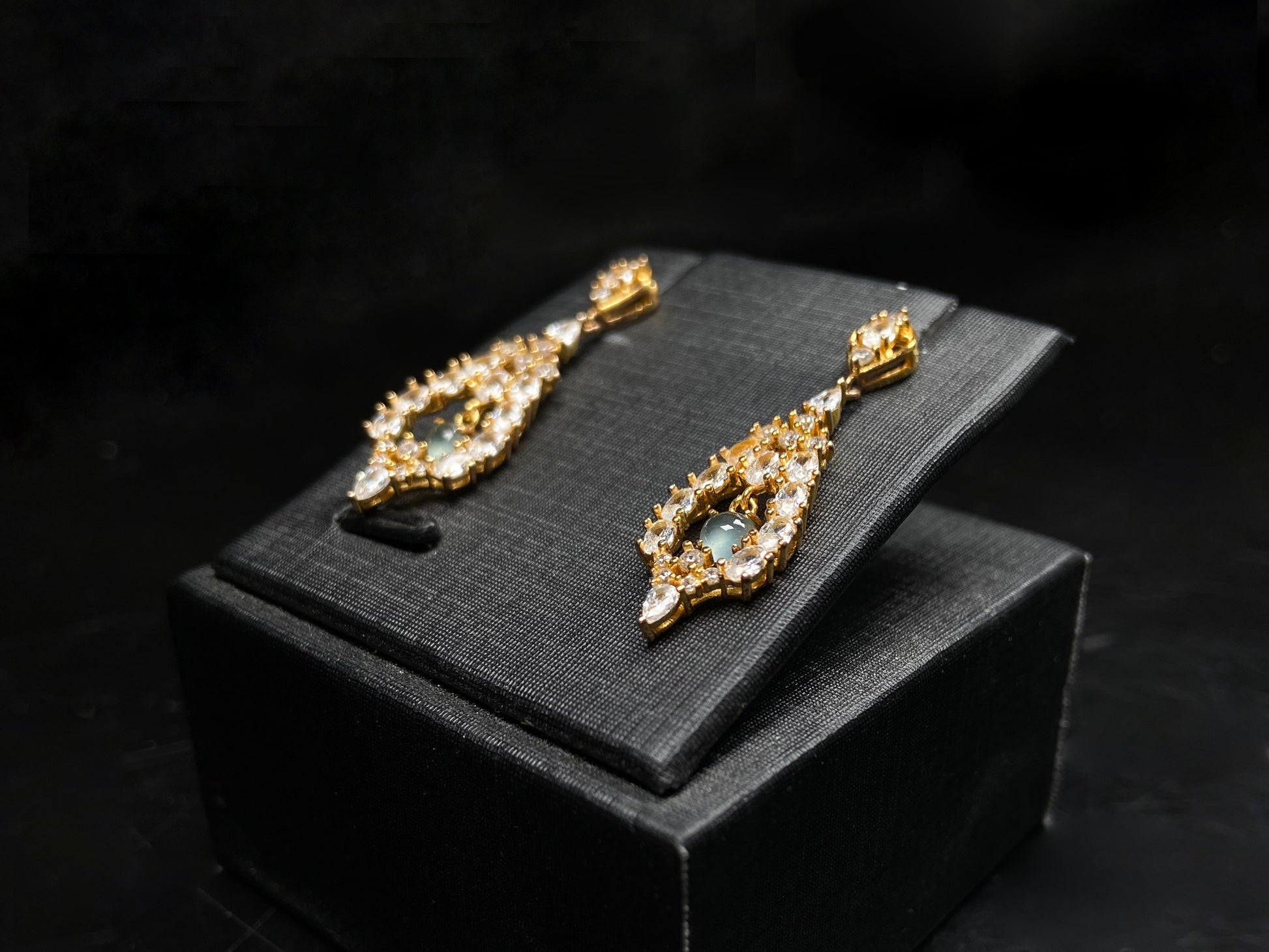 A  pair of diamond halo clear teardrop jadeite earrings.