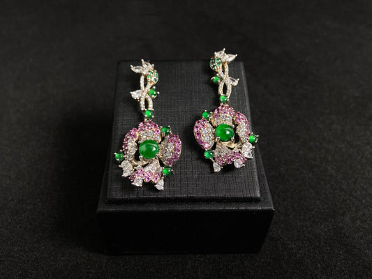 Floral earrings with green jade beads, featuring rose gold edges and silver bases.