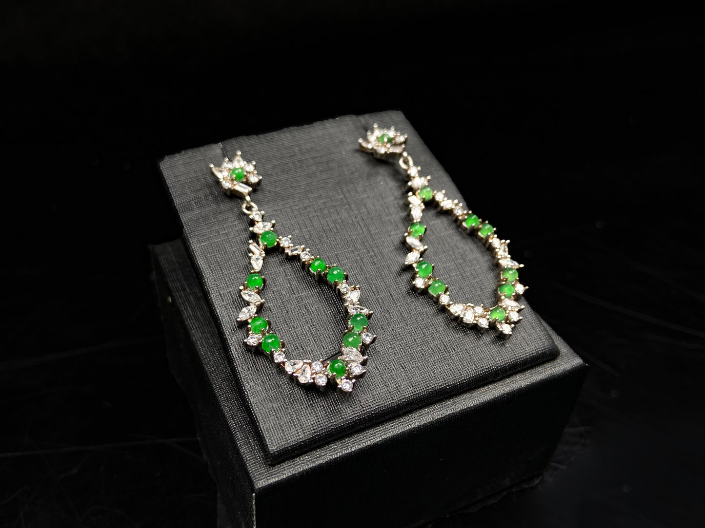 A green teardrop garland jadeite earrings.