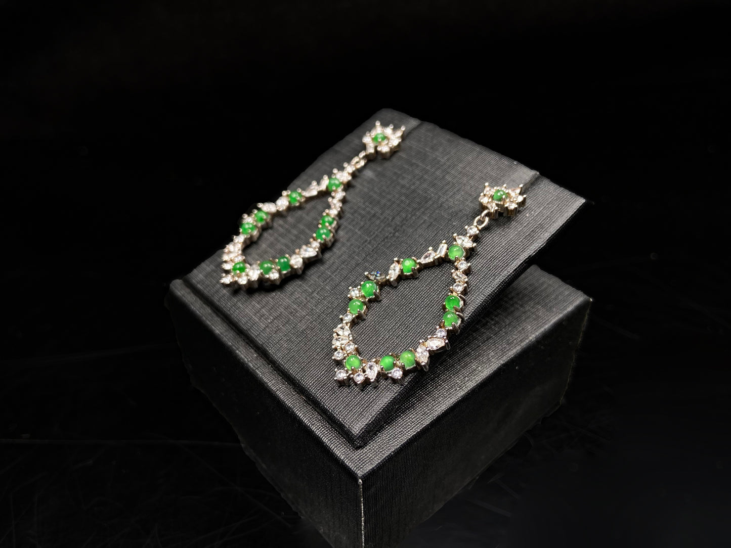 A green teardrop garland jadeite earrings.