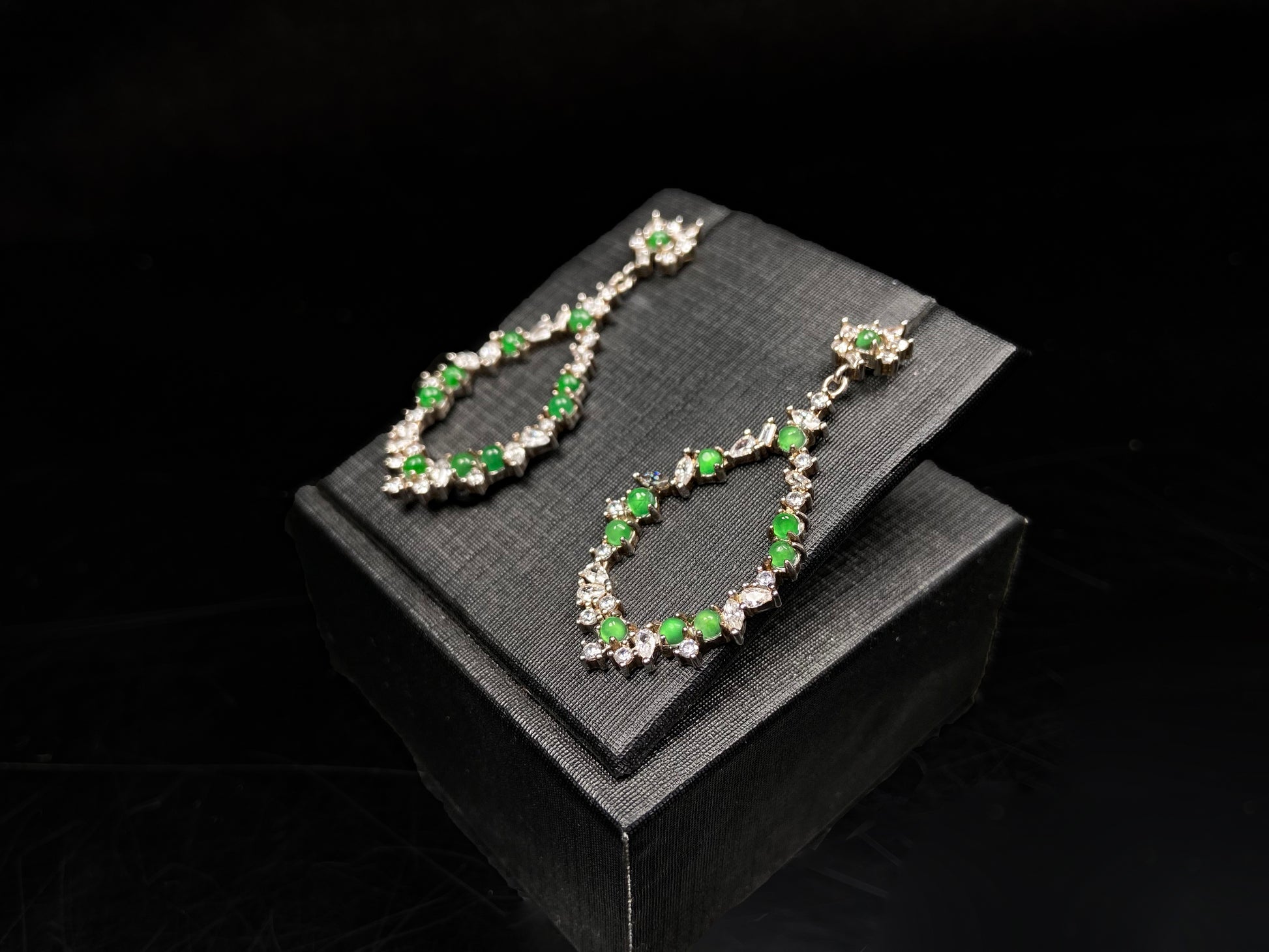 A green teardrop garland jadeite earrings.