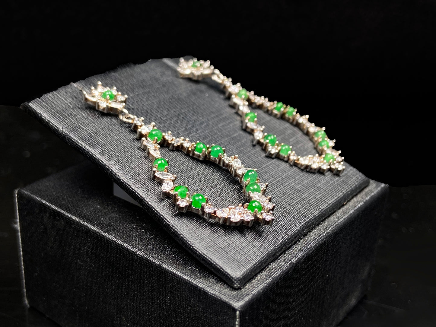 A green teardrop garland jadeite earrings.