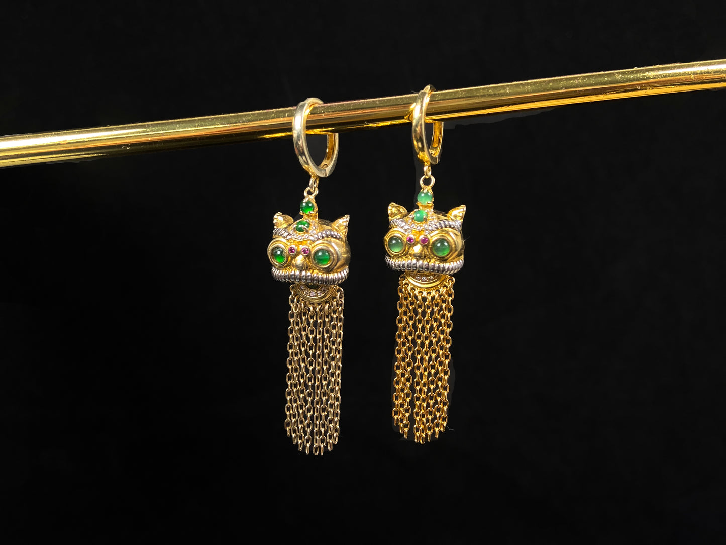 A golden Foo Dog green accent jadeite earrings.