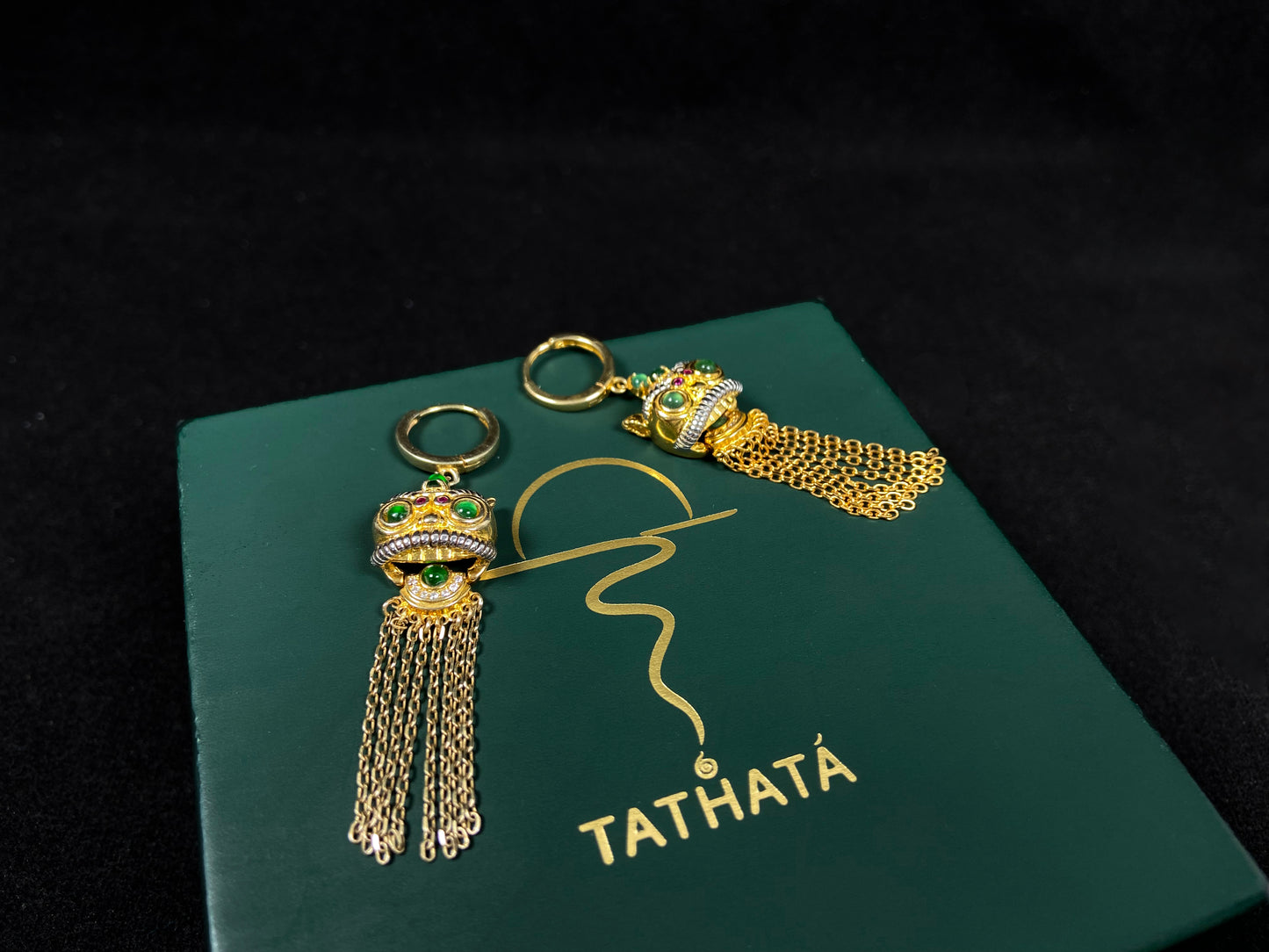 A golden Foo Dog green accent jadeite earrings.