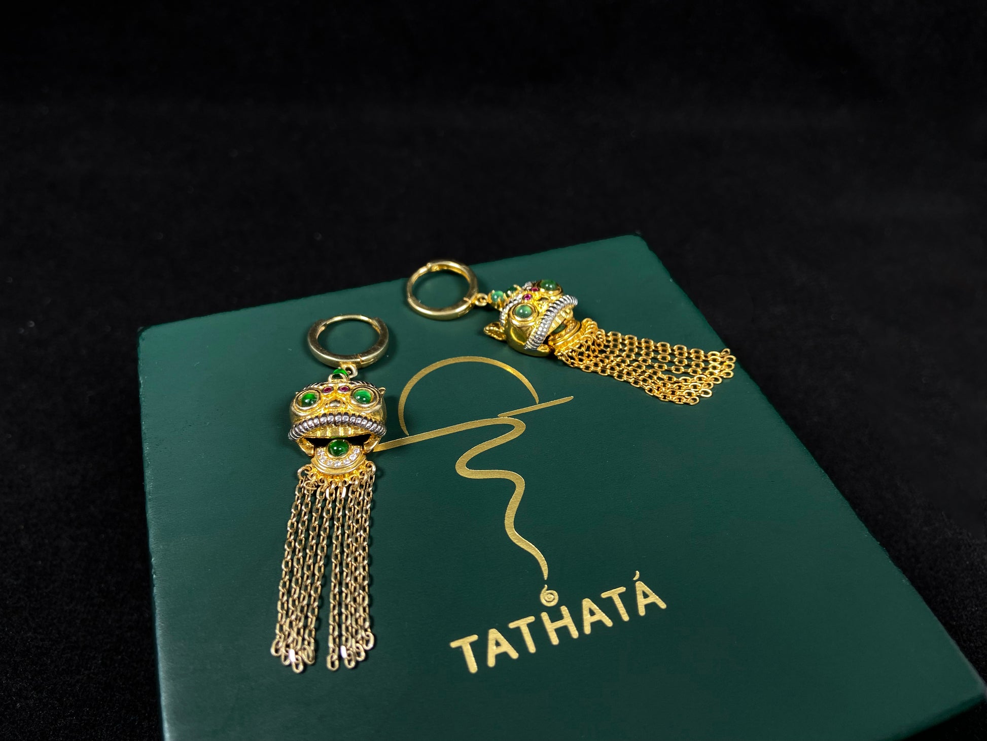 A golden Foo Dog green accent jadeite earrings.