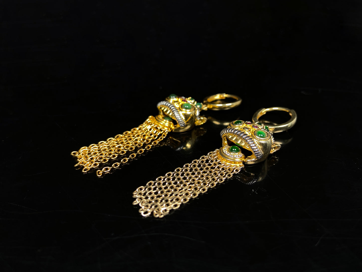 A golden Foo Dog green accent jadeite earrings.