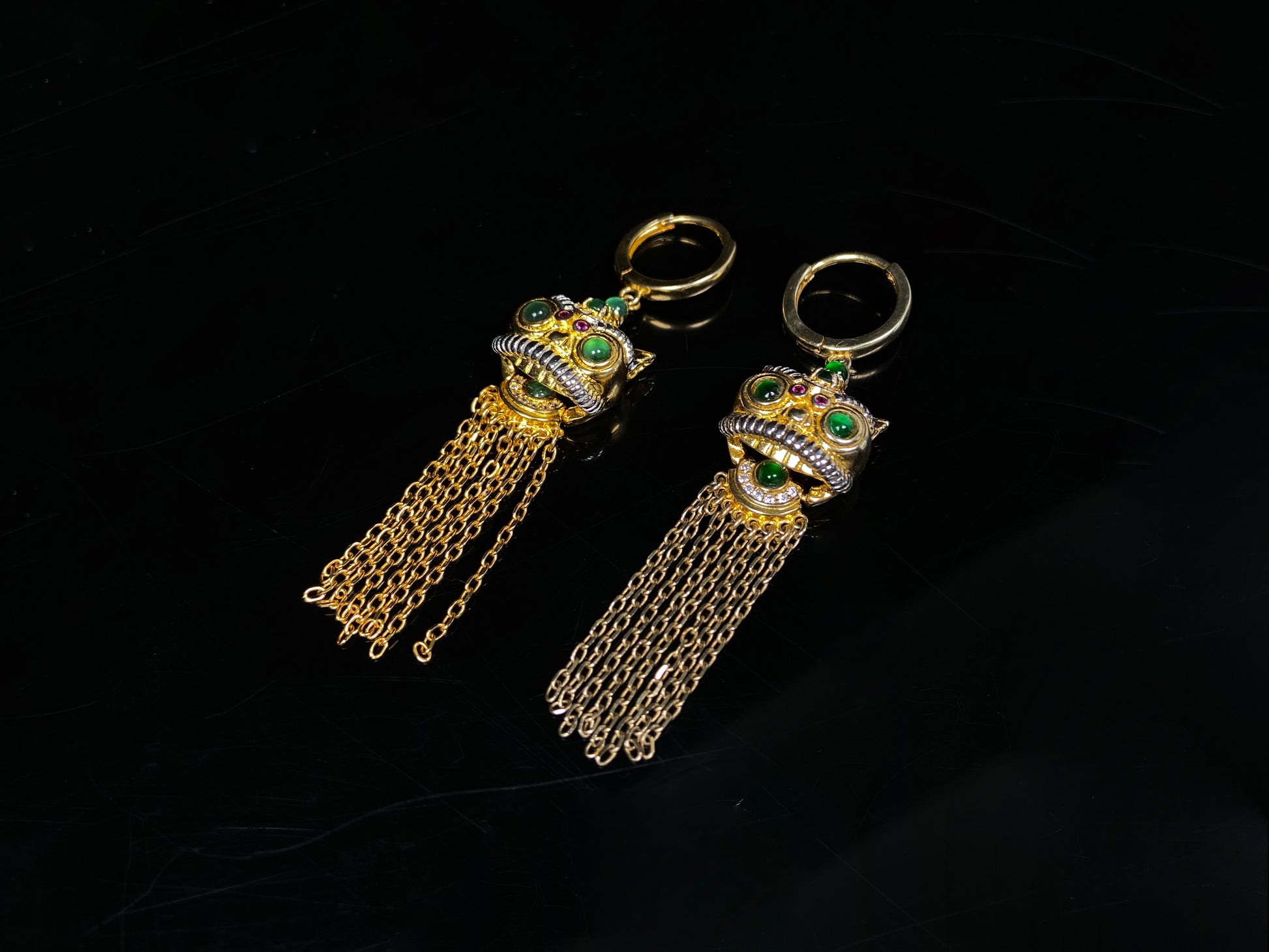A golden Foo Dog green accent jadeite earrings.