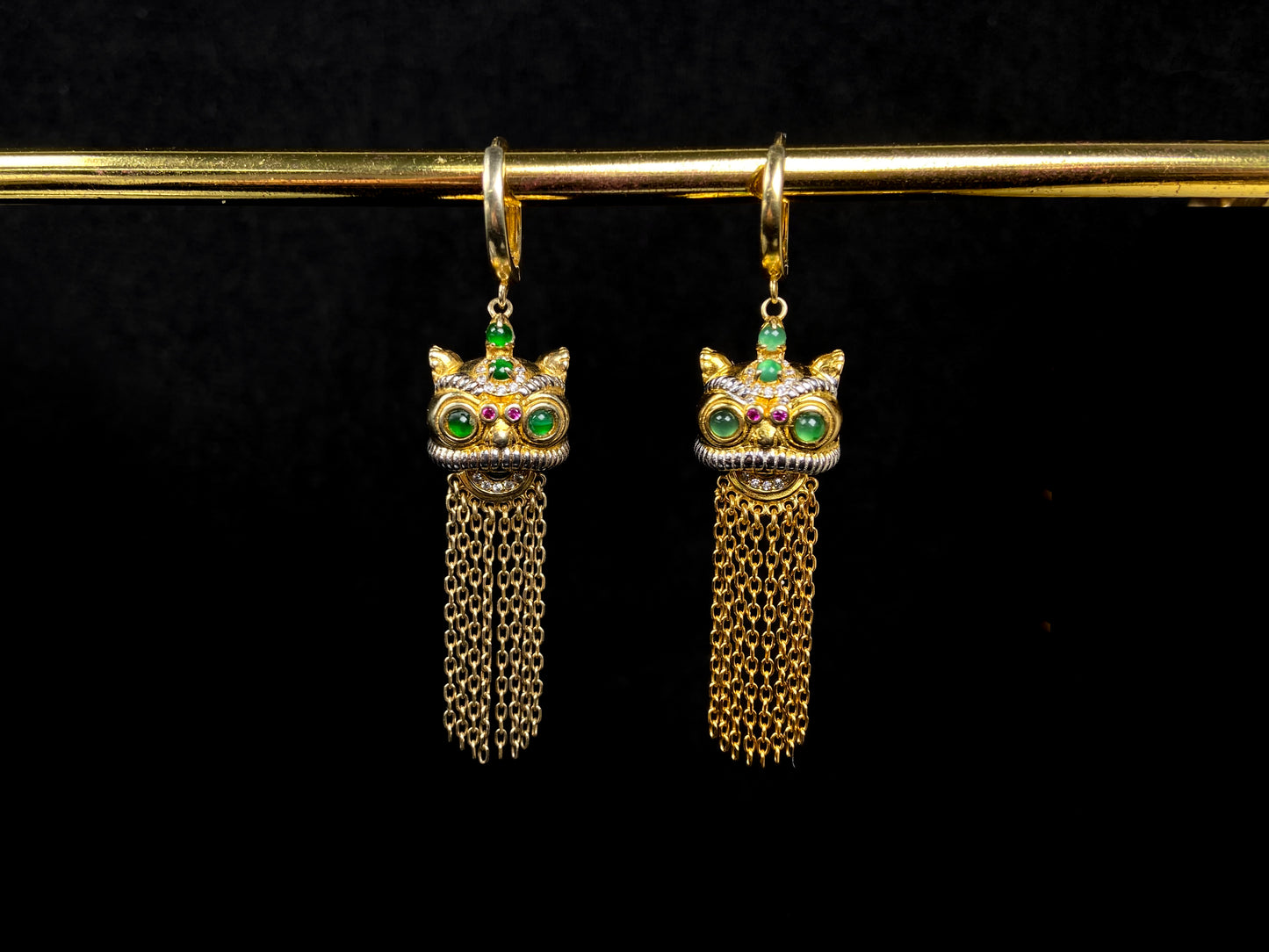 A golden Foo Dog green accent jadeite earrings.