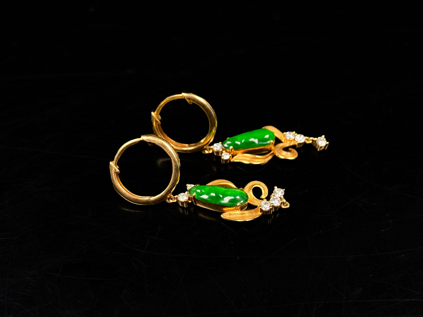 A pair of vivid green snap pea jadeite earrings.