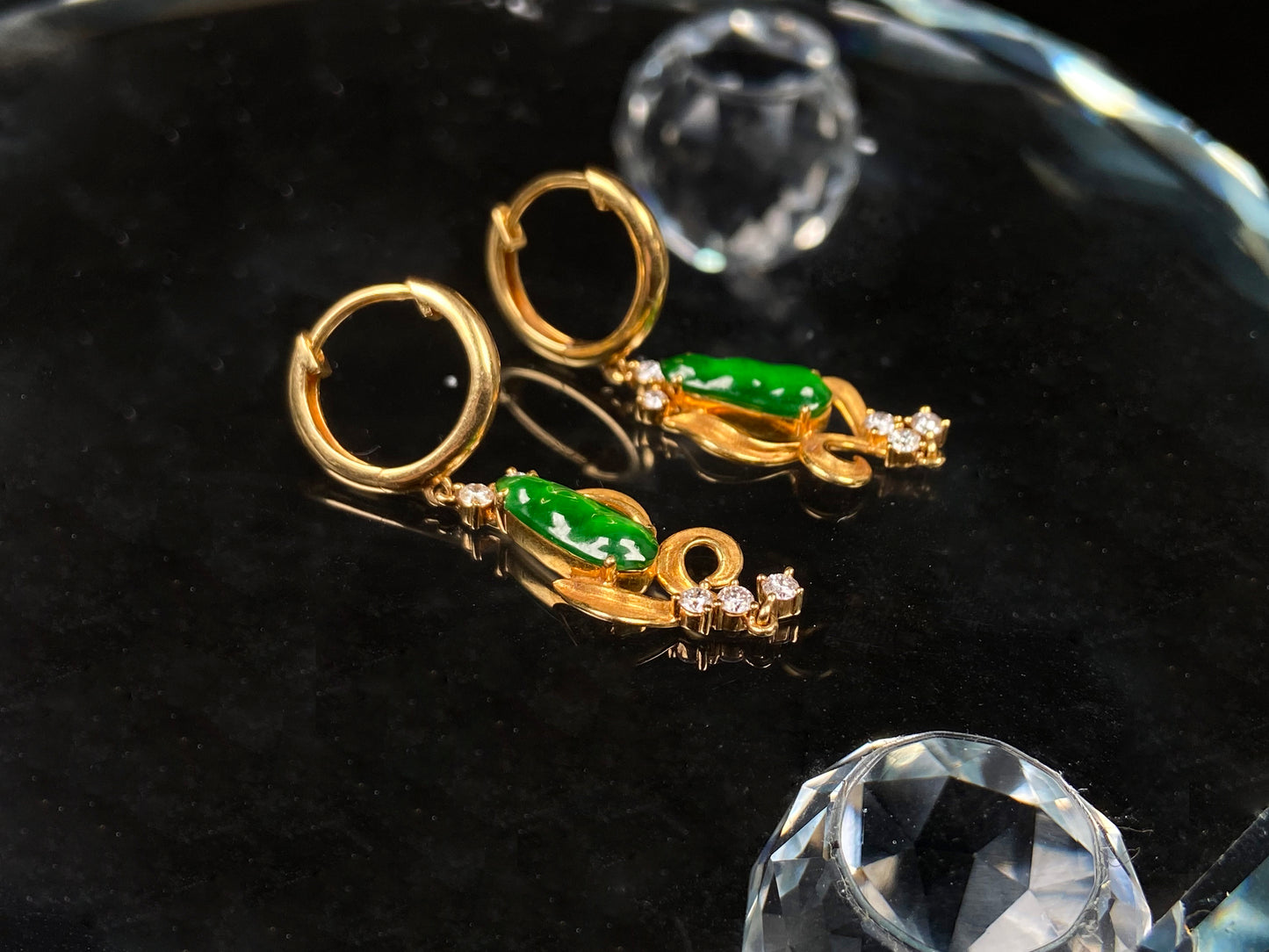 A pair of vivid green snap pea jadeite earrings.