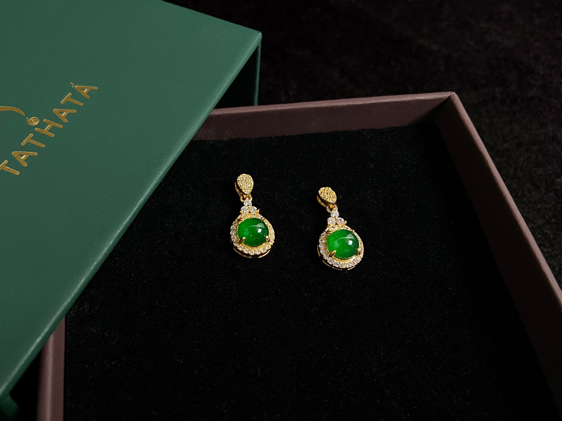 Imperial green jade beads set in gold plated silver with secure prong settings.