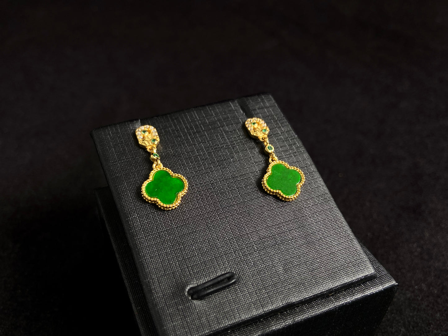 These elegant earrings feature bean green jadeite four leaf clovers, each beautifully framed in gold plated 925 silver.