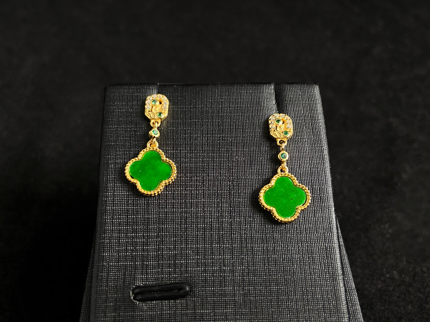 These elegant earrings feature bean green jadeite four leaf clovers, each beautifully framed in gold plated 925 silver.