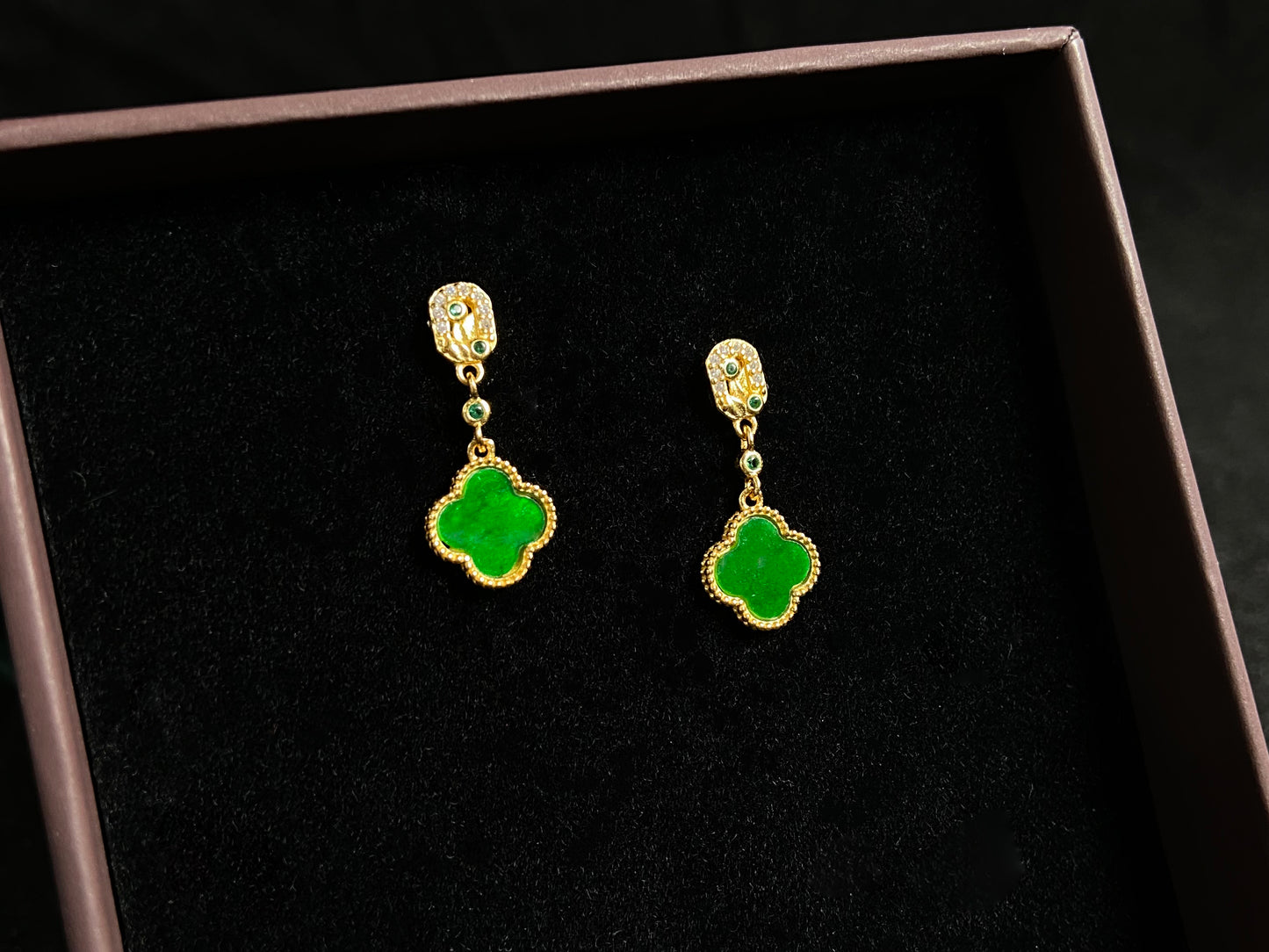 These elegant earrings feature bean green jadeite four leaf clovers, each beautifully framed in gold plated 925 silver.