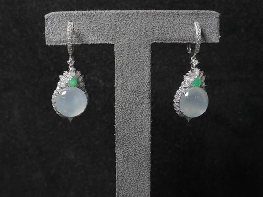 Icy moon drop green accent jadeite earrings.
