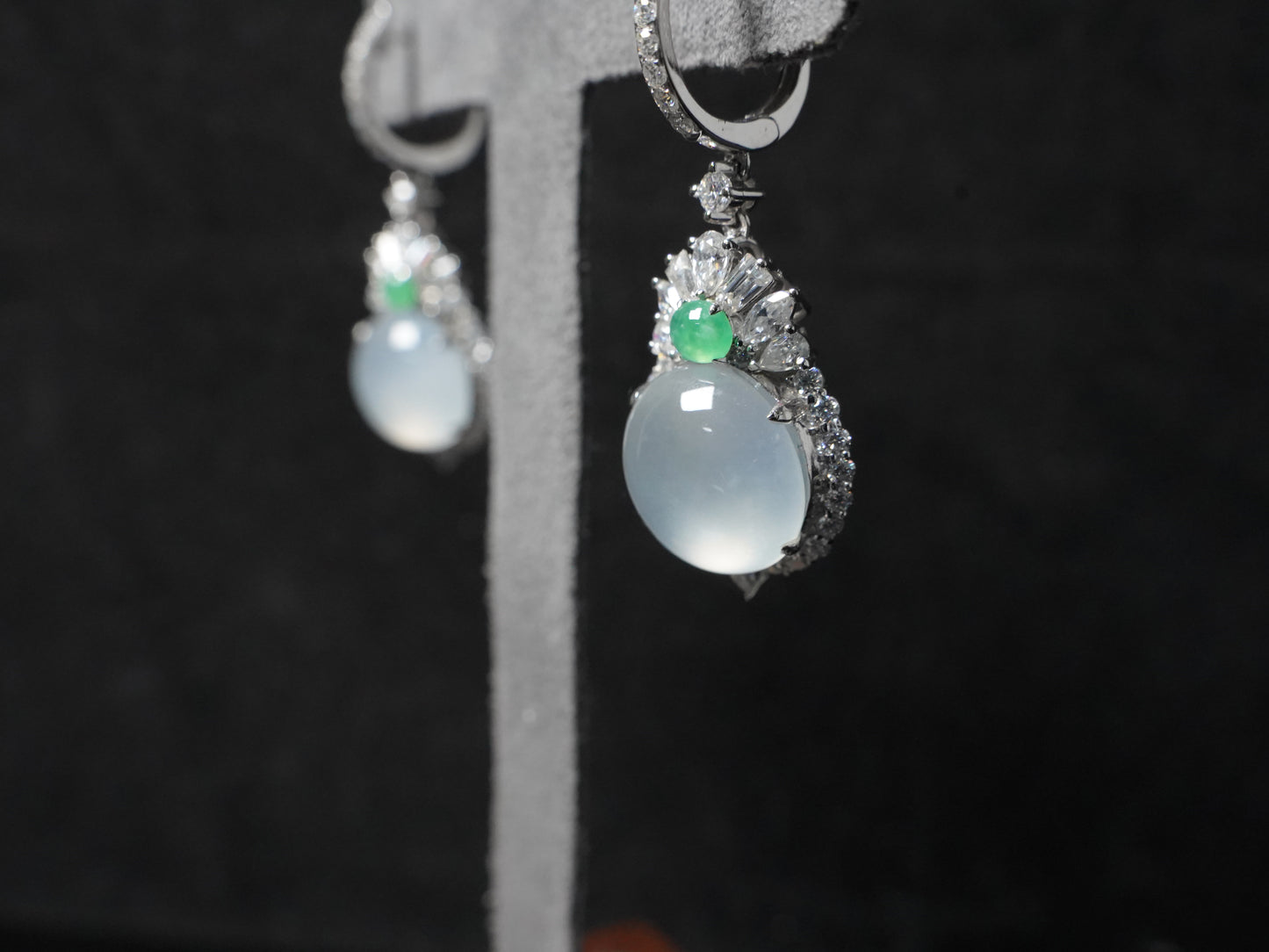 Icy moon drop green accent jadeite earrings.