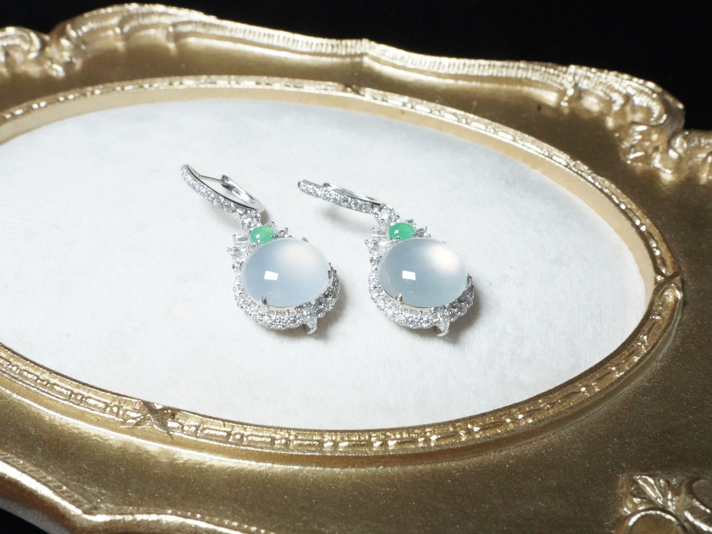 Icy moon drop green accent jadeite earrings.