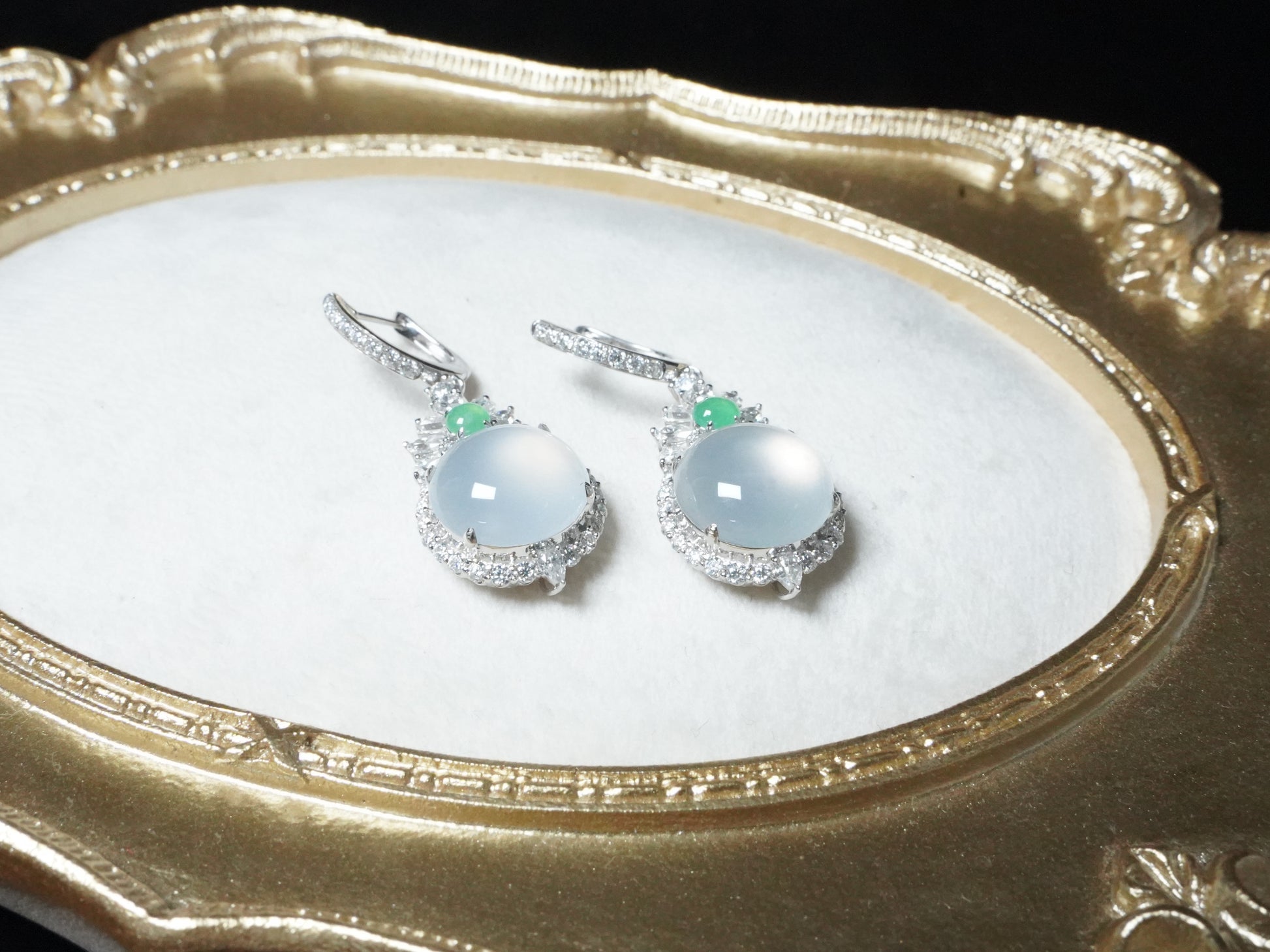 Icy moon drop green accent jadeite earrings.