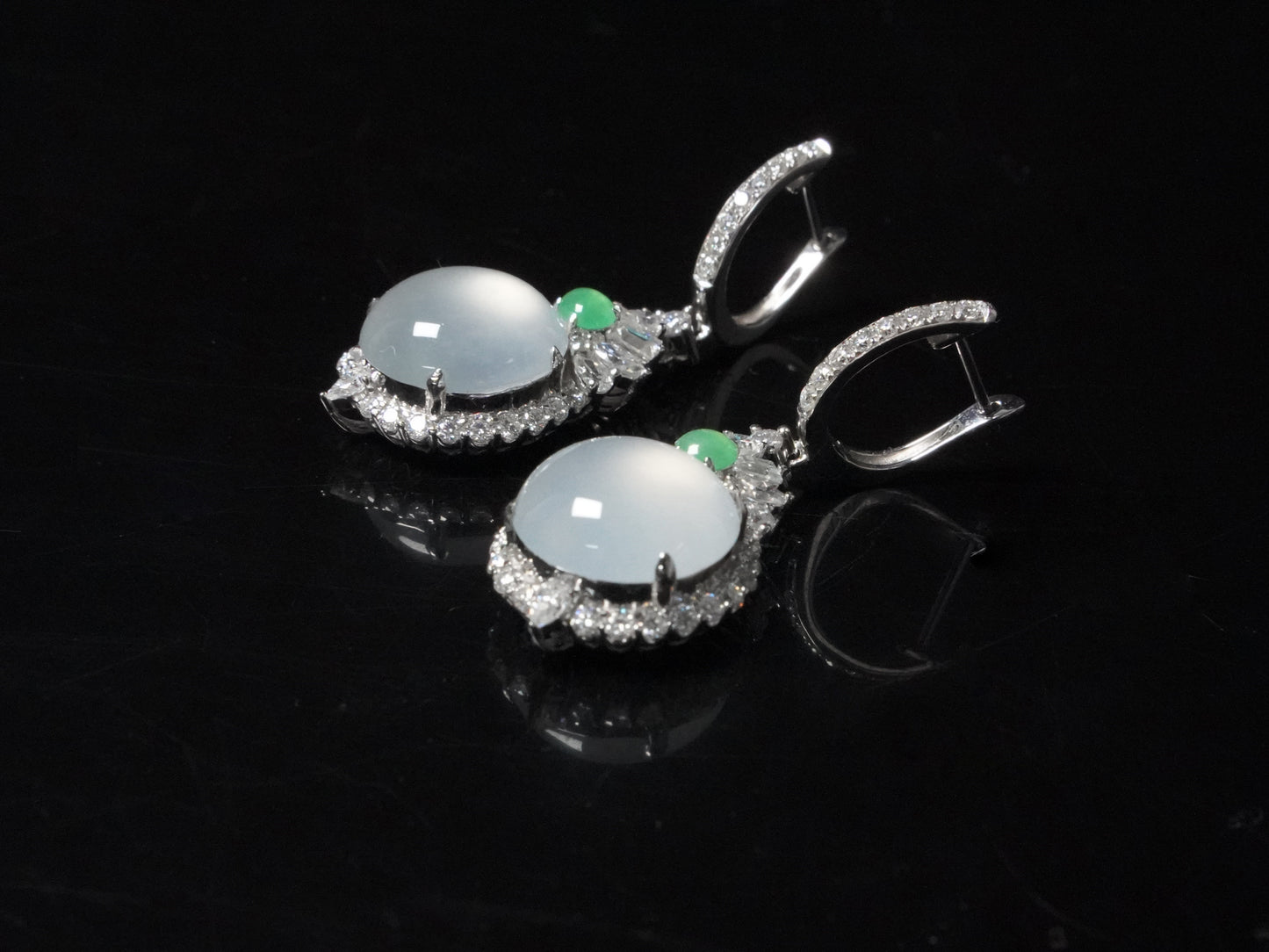 Icy moon drop green accent jadeite earrings.