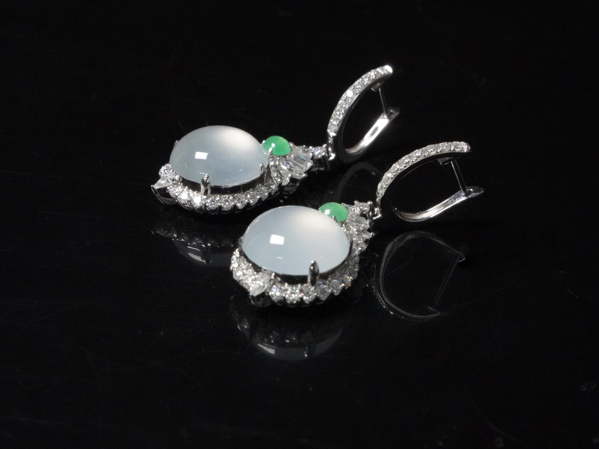 Icy moon drop green accent jadeite earrings.