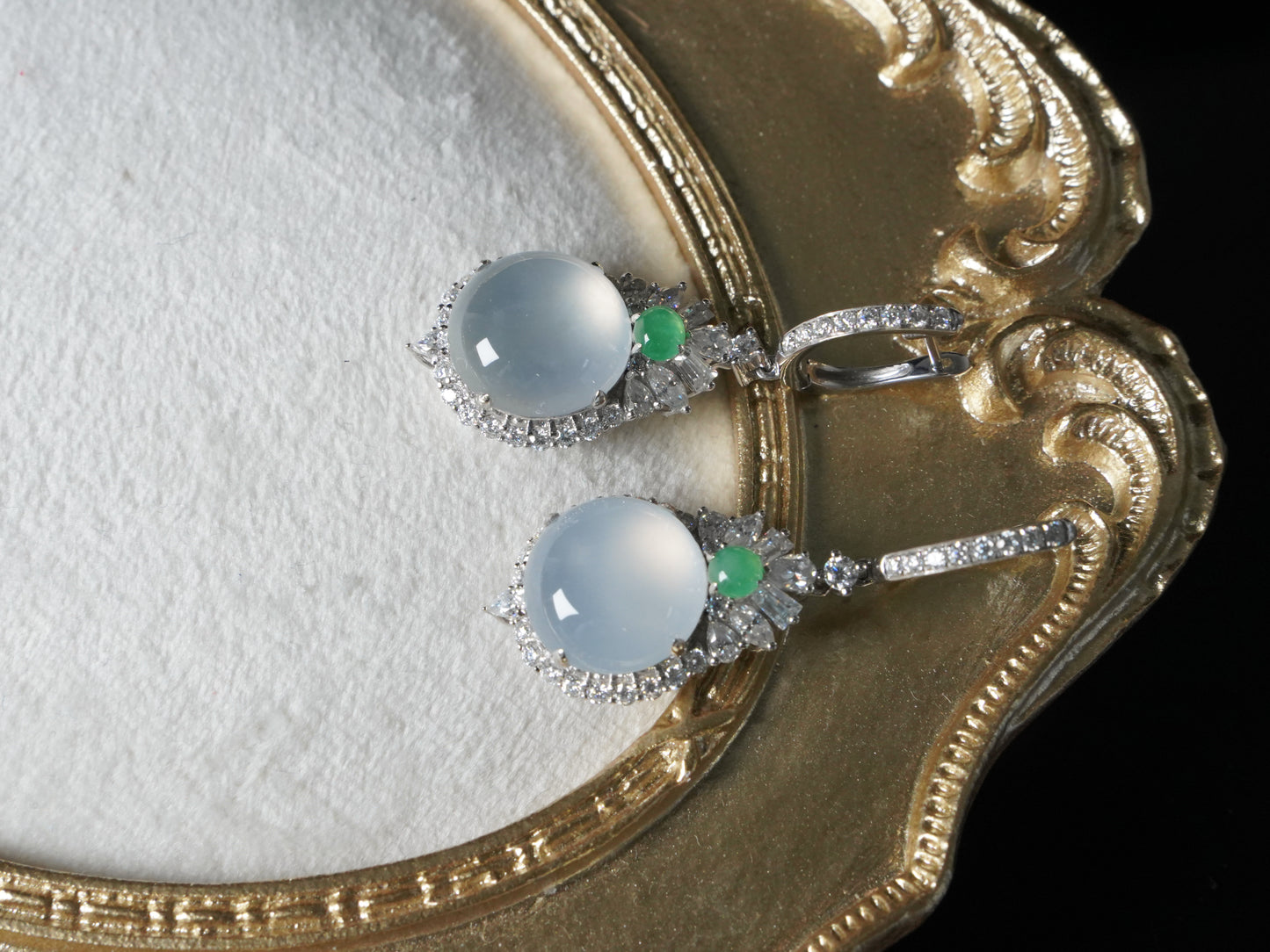 Icy moon drop green accent jadeite earrings.