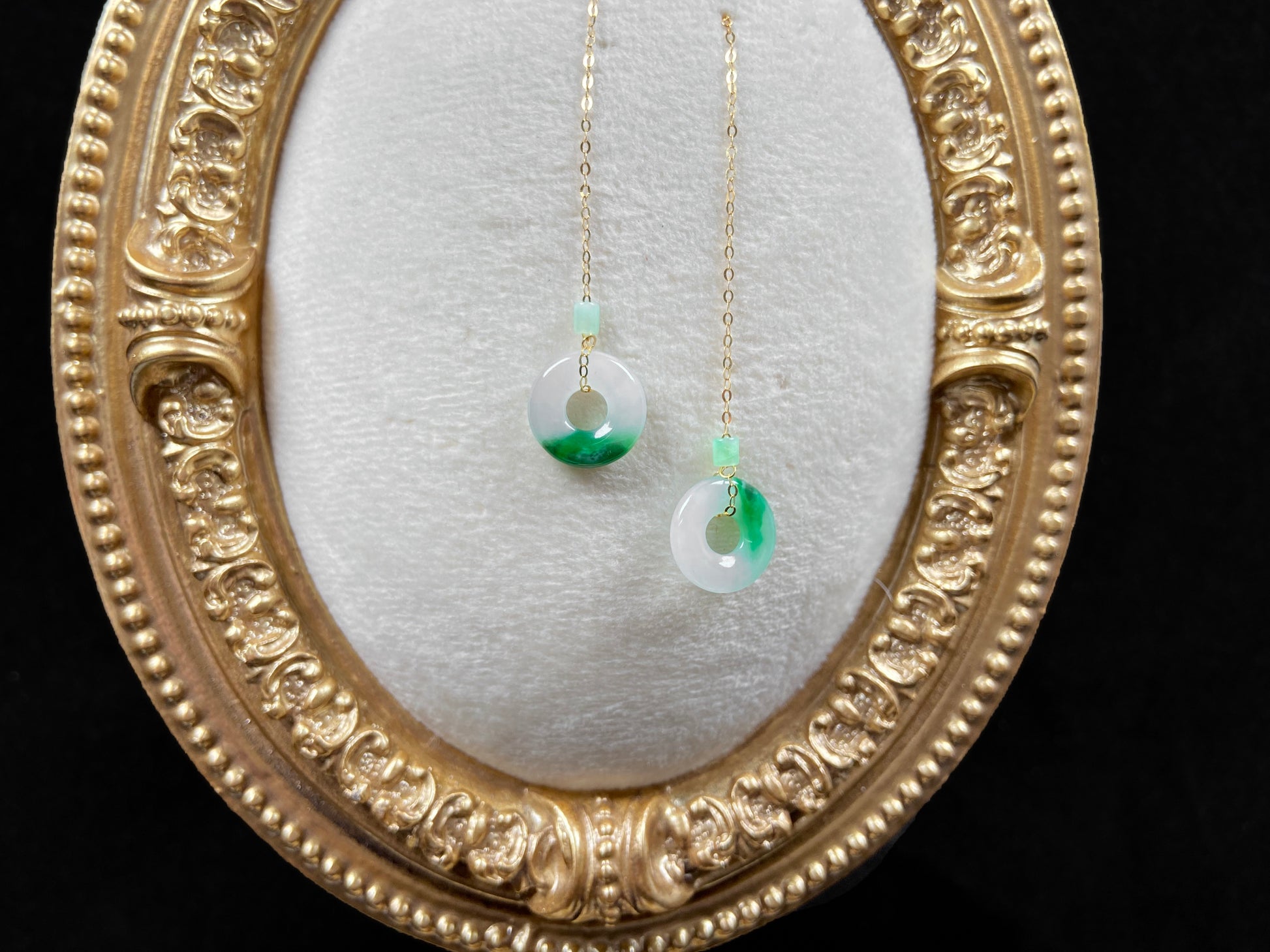 A white green donut jadeite earring.