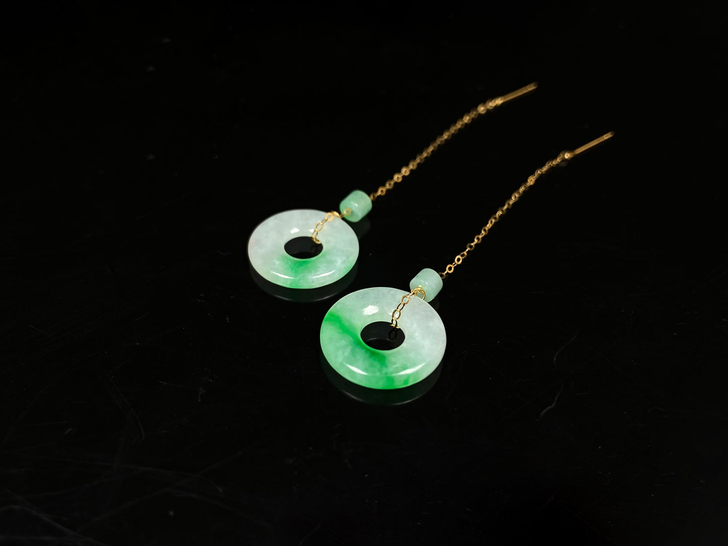 A milky white green cloud donut jadeite earring.